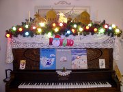 Christmas decorations on top of a piano